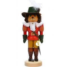 a wooden nutcracker with a green hat and feathered tail, standing on a white background