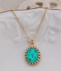 "A stunning new color opal for my best selling line. I love to bring my customers rare and unique color opals and these are no exception! These are a stunning shade of aqua peacock blue with green highlights. The stones are set into a 14K gold plated crown edge setting. Opal measures 10mm tall (just under 1/2\") and hangs from a 14K gold filled chain. Please choose desired chain length at checkout. VERY limited supply of this special color! Please choose, at checkout, if you prefer a 14K gold fi Turquoise Opal Jewelry As Gift, Turquoise Opal Jewelry As A Gift, Turquoise Opal Jewelry For Gift, Blue Opal Pendant Jewelry, Blue Opal Gemstone Necklaces, Blue Opal Gemstone Necklace, Green Opal Birthstone Jewelry, Blue Opal Round Necklace, Blue Opal Round Pendant Jewelry