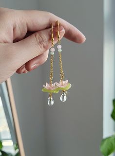 "Add something extra to your outfits with these lily pad lotus flower earrings! Made with gold plated wire, shrink plastic, and glass beads. The dangle length is around 6.5cm/2.5\". Each pair is lovingly handmade! 🎀 CARE INSTRUCTIONS 🎀 * Avoid getting your jewelry wet * Avoid perfumes or sprays * Store in a cool, dry place" Dangle Flower Earrings, Lily Pad Earrings, Water Lily Earrings, Elegant Accessories Jewelry, Lotus Accessories, Lotus Flower Earrings, Bead Flower Earrings, Flower Drop Earrings, Cute Jewelry Diy