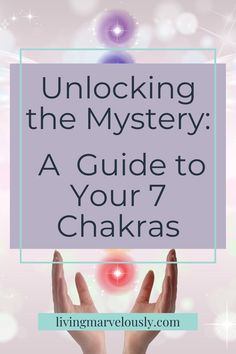 hands holding up a sign that says unlock the mystery a guide to your 7 chakras