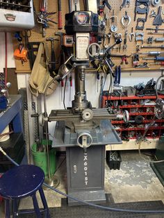 a machine shop with many tools on the wall