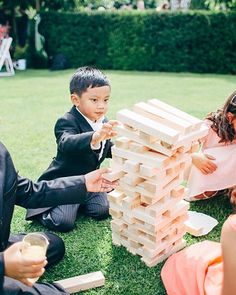 children playing with wooden blocks on the grass