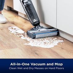 a person cleaning the floor with a vacuum and mop