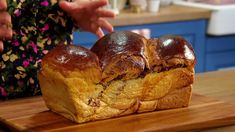 a wooden cutting board topped with two pieces of bread