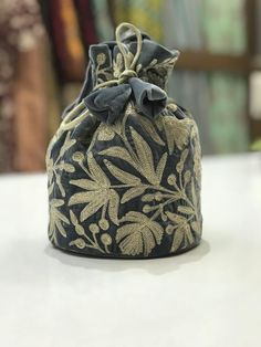 Complete your traditional looks with this lovely potli bag on your wrist, which is trendy yet compact enough to carry your essentials in style. This potli bag will be a pretty inclusion in your accessory collection and perfect for taking in a party.This bag can also be used as a wedding favour bag. It is perfect as a gift for weddings, bridal showers, baby showers, wedding receptions - excellent to fill with candy, dry fruits, sweets, herbs, soap, something remarkable for your guests that no one Embroidered Clutch Potli Bag Gift, Traditional Gold Embroidered Pouch Clutch, Traditional Gold Embroidery Pouch Clutch, Traditional Floral Embroidered Pouch Clutch, Traditional Potli Bag With Gold Embroidery For Gifts, Handheld Embroidered Potli Bag For Festivals, Gold Embroidered Pouch As Gift, Daily Use Embroidered Bucket Bag, Traditional Bags With Floral Embroidery For Daily Use