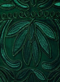 an image of green fabric with leaves on it