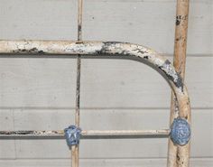 an old metal bed frame with peeling paint on it