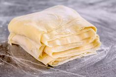 a pile of uncooked bread sitting on top of a table