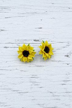 "Charm sunflower earrings for every lovely day. The life of the real sunflowers is too short to make some flower earrings with them. Instead of real flowers, I offer you these beautiful handmade flowers that will never fade. Such a piece of floral jewelry can please you for many years. They will beautifully adorn your look in any season of the year. Details: * Designed with handmade flowers out of cold porcelain (air dry clay); * Diameter of the flowers is about 1\" (2.5cm); * Base color will be Sunflower Earring, Sunflower Charm, Real Leaves, Sunflower Earrings, Pink Rose Flower, Floral Jewelry, Easy Day, Lilac Flowers, Seasons Of The Year