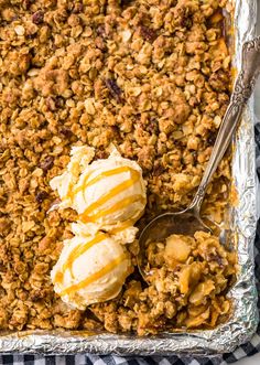 a pan filled with ice cream and granola on top of a checkered table cloth