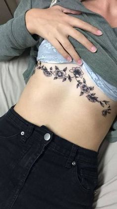 a woman with a tattoo on her stomach