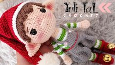 a crocheted stuffed animal wearing a red and green outfit with matching mittens