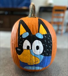 a cartoon character painted on an orange pumpkin