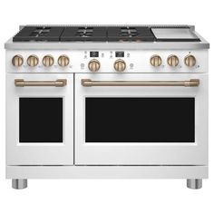 a white stove top oven with two burners on each side and gold knobs