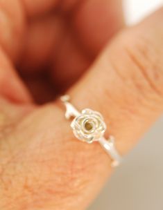 NEW ! An Original Design A rose with a tiny throned band makes a sweet statement. I love the thorns, the roses pretty swirled center and petal details on this ring. When I made this ring I wanted it modern, pretty, and a little edgy. I can also set a small stone in the center curl of the rose for an up charge. Please see last 2 pictures for this. Rose measures 7.5 mm. Ring is all sterling silver. I can also make in 14 karat gold solid. Original design by Teri Lee Rose Design Promise Jewelry, Delicate Rose Design Rose Colored Ring, Rose-colored Promise Rings With Rose Design, Dainty Rose Design Flower Promise Ring, Eine Rose, Rose Ring, A Rose, The Rose, Ring Verlobung