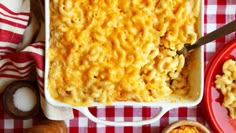 a red and white checkered table cloth with macaroni and cheese in a casserole dish