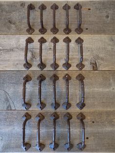 several old style metal handles on wooden boards