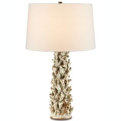 a table lamp with a white shade on it's base and a light bulb in the shape of a pine cone