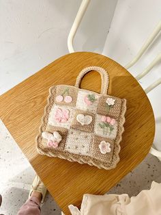 a handbag sitting on top of a wooden chair