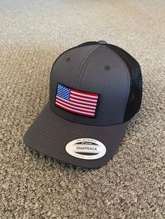 This is a NEW United States of America Flag Embroidered Patch applied by hand to a high quality Yupoong or Richardson SnapBack trucker hat (photos show the brand of hat used for color selection) Yupoong Classic SnapBacks are 65% Polyester/35% Cotton, Structured, mid-profile, 3 1/2" crown, six-panel Permacurv Visor adjustable plastic snapback closure 6 7/8" to 7 1/2" Richardson Hats are 60% cotton/40% polyester Structured, mid-profile, six-panel Pre-curved Visor adjustable plastic snapback closure 6 3/4" -7 5/8" Every Hat Design is Created and Individually HANDCRAFTED to order in Florida *Due to sanitary concerns, and to ensure that every customer receives a brand new and unworn hat that is custom made to order, we cannot accept returns All hat designs are individually handcrafted in Florid United States Of America Flag, Richardson Hats, American Flag Hat, Flag Hat, America Flag, Love Hat, Custom Hats, Snapback Cap, Black Mesh