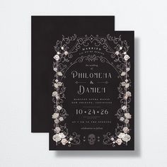 a black and white wedding card with flowers on the front, in an ornate frame