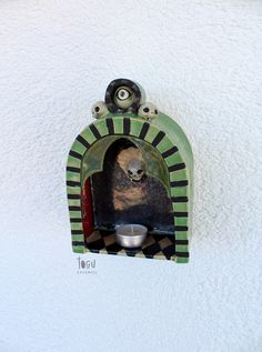 a dog is sitting in his kennel with its food bowl