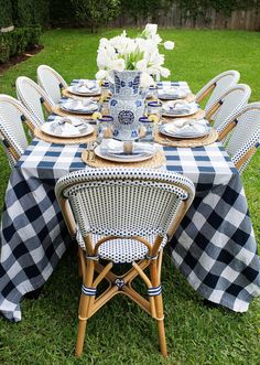 the table is set up with blue and white checkered cloths on it,