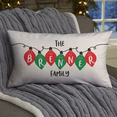 a pillow that says the brenner family with christmas lights hanging from it's sides