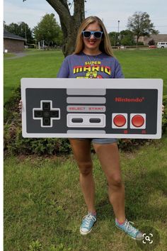 a woman holding up a nintendo game controller costume