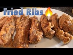 fried ribs on a white plate with a flame in the background that says fried ribs