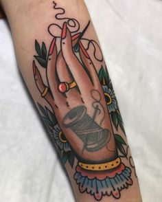 a woman's arm with a tattoo on it that has a praying hand holding a lit candle