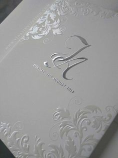 a white wedding card with the letter s on it