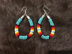 Authentic Beautiful Native American Indian Jewelry Navajo Zuni Hand Beaded  2 3/8inch Hoop Earrings Handcrafted by Navajo Artist Harriet Crosby Great for a  Gift❤️ Present in virtually every Native American tribe, the feather symbol is universally recognized as a representation of trust, strength, wisdom, freedom, and honor. Incorporated into many sacred pieces of Native American wear, the feather is easily one of the most respected symbols. Southwestern Style Beaded Earrings, Southwestern Style Beaded Dangle Hoop Earrings, Southwestern Style Earrings With Colorful Beads, Southwestern Teardrop Beaded Earrings, Southwestern Style Beaded Earrings For Festival, Southwestern Teardrop Jewelry With Colorful Beads, Southwestern Multicolor Teardrop Beaded Earrings, Southwestern Multicolor Beaded Earrings, Adjustable Southwestern Beaded Earrings