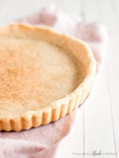 a tart crust on a pink napkin with the words, prebaked tart crust