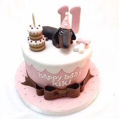 a birthday cake with a dog on top