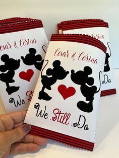 someone is holding up some personalized mickey mouse cards