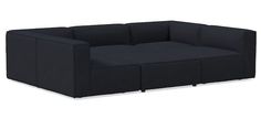 a black couch sitting on top of a white floor