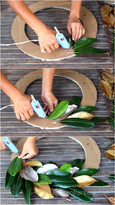 someone is using scissors to cut leaves out of cardboard and put them on top of each other