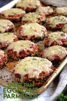 a baking pan filled with meat patties covered in cheese