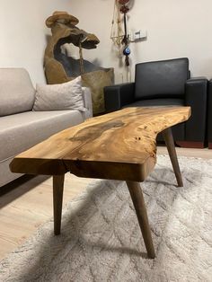 a wooden table sitting on top of a white rug