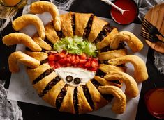 a plate with some food on it that is shaped like a spider and has googly eyes