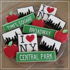 decorated cookies with i love new york, times square and broadway in green on a plate