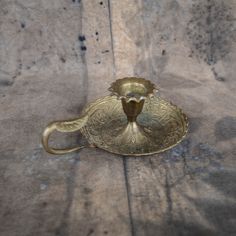 an antique brass teapot on a table