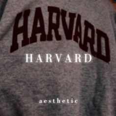 the back of a gray shirt that says harvard with brown letters on it and an arch across the chest