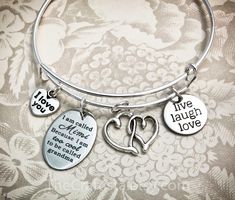 "Mimi is another word for Love! Themed gifts magnify our thoughtful gesture and make the recipient feel extra special. This bangle includes: ♥ entwined hearts charm (20mm) ♥ engraved charm (15 mm) that reads: live laugh love ♥ heart charm (10 mm) engraved with the words \"I love you\" ♥ engraved charm (17 x 24 mm) that reads: I am called Mimi because I am too cool to be called grandma ♥ adjustable bangle 60mm in size (expandable to fit wrist 7-8\") Bangle is made from 1.5mm (14 gauge) wire - the Inspirational Charm Bracelet For Mother's Day, Mother's Day Sterling Silver Friendship Charm Bracelet, Sterling Silver Charm Bracelet For Friendship On Mother's Day, Mother's Day Sterling Silver Charm Bracelet For Mom, Mother's Day Charms Bracelet Gift For Mom, Mother's Day Engraved Charm Bracelet, Personalized Charm Bracelet For Mother's Day Gift, Customizable Charm Bracelet For Mother's Day Anniversary, Gifts For Mimi