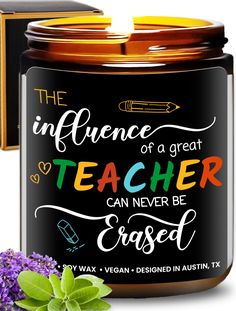 an open jar of teacher's scented candle next to purple flowers and green leaves