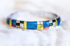 Mondrian Inspired Bangle, Cubism Jewelry, Resin Bracelet Mondrian Born 7 March 1872 - Died 1 February 1944 (aged 71) Stacking Resin Bangle Design , totally Handmade silicone molds for bangles made by us PAGANE uniques Pieter Cornelis Mondrian was a famous abstract Cubism painter, born in the Netherlands. His most recognized works are abstract paintings of colored squares, rectangles, and thick black lines.We love his minimal art , and that's why we decided to create a bracelet with his design in Multicolor Nickel-free Bracelets For Festivals, Nickel-free Multicolor Festival Bracelets, Multicolor Hand Painted Bangle Jewelry, Hand Painted Multicolor Bangle Jewelry, Artsy Multicolor Bangle Jewelry, Nickel-free Multicolor Beaded Bangle Bracelets, Handmade Multicolor Wearable Art Bracelets, Artsy Multicolor Bracelet Jewelry, Artsy Multicolor Jewelry Bracelet