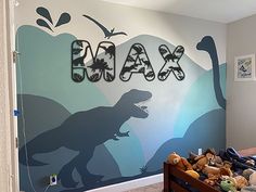 a child's bedroom decorated with dinosaur wall decals