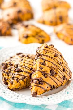 two chocolate chip cookies on a white plate