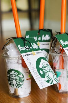 starbucks coffee cups with orange straws in them